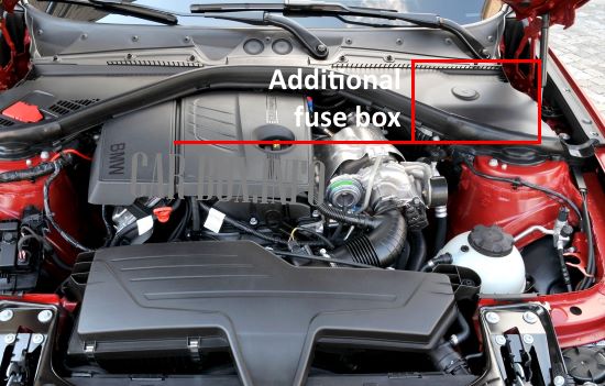 Place of installation of the additional unit in the engine compartment of the car